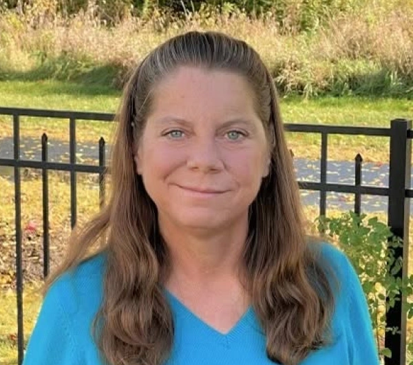 Portrait of Dr. Jennifer Lebbin outdoors wearing a blue sweater