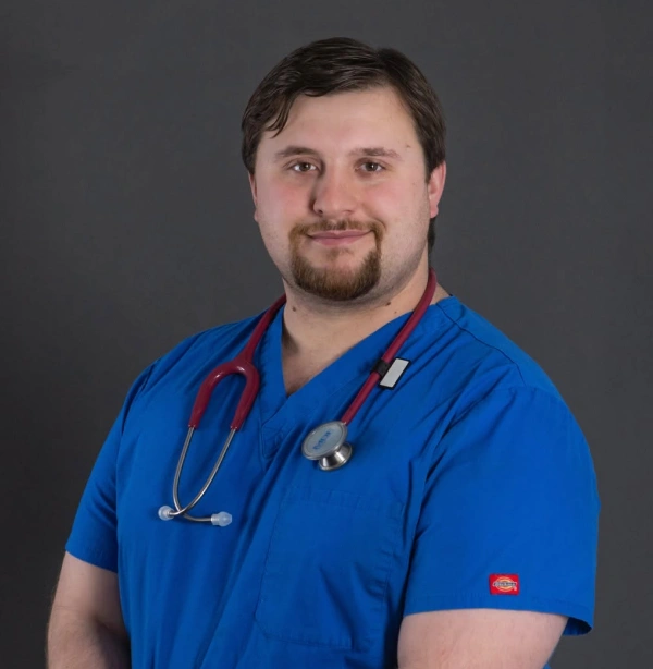 Portrait of Dr. Kenneth Winebaugh in blue scrubs with a stethoscope